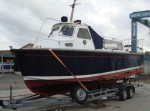 A vintage customs launch being transported locally. - click to enlarge